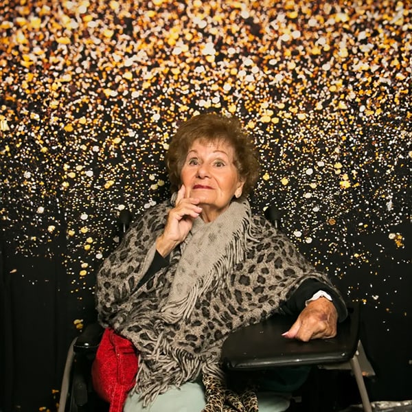 Senior resident posed against a festive backdrop