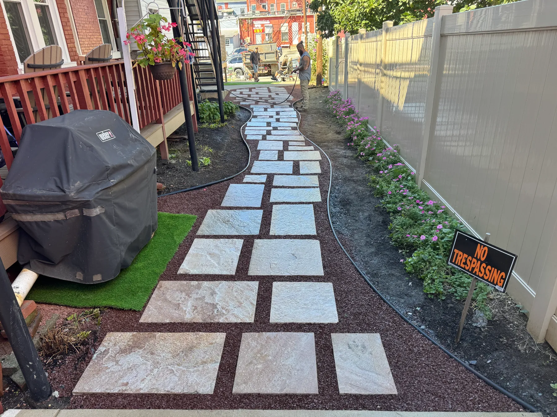 Pathway with pavers and flowers in outdoor space.