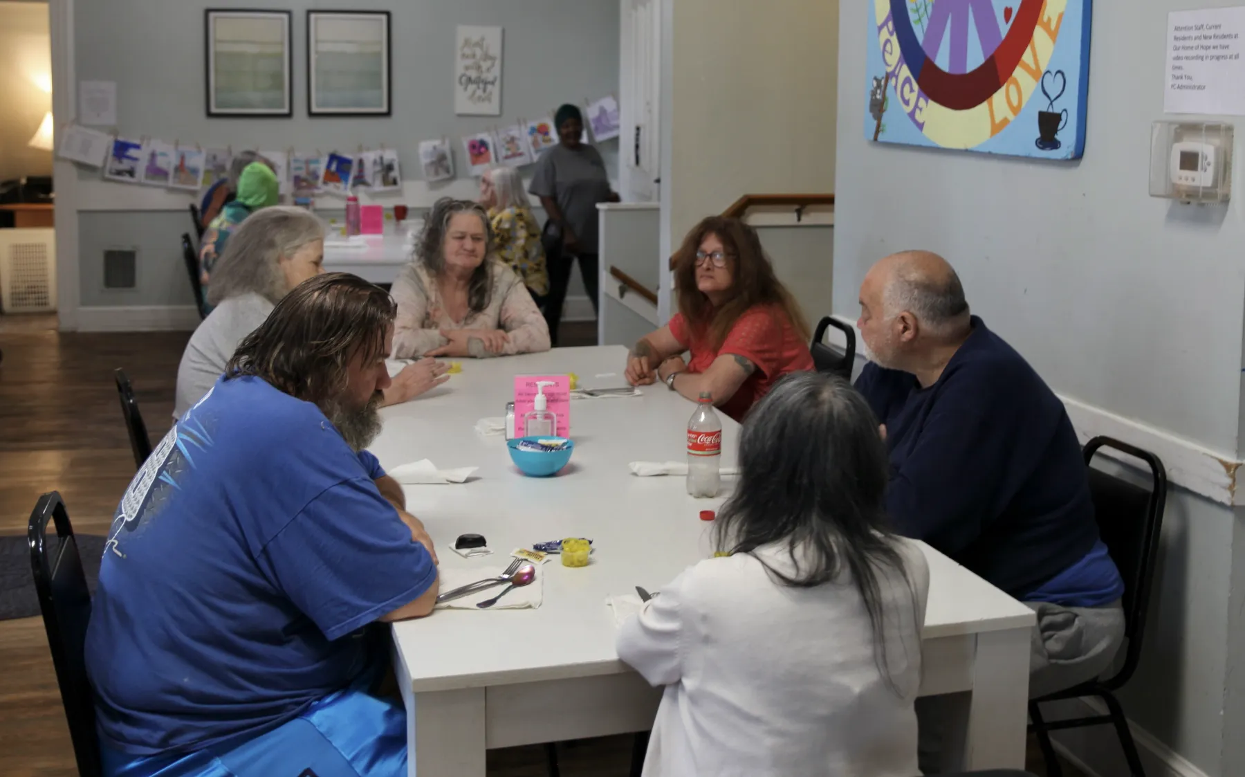 Residents engaged in conversation around a table.