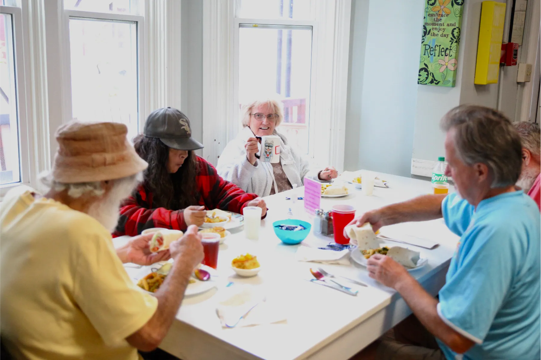 Residents enjoying a meal together in a dining room.