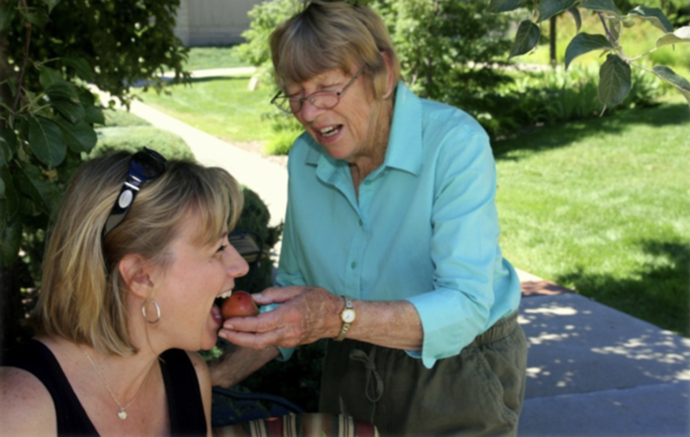 A resident and staff member enjoying time outdoors.