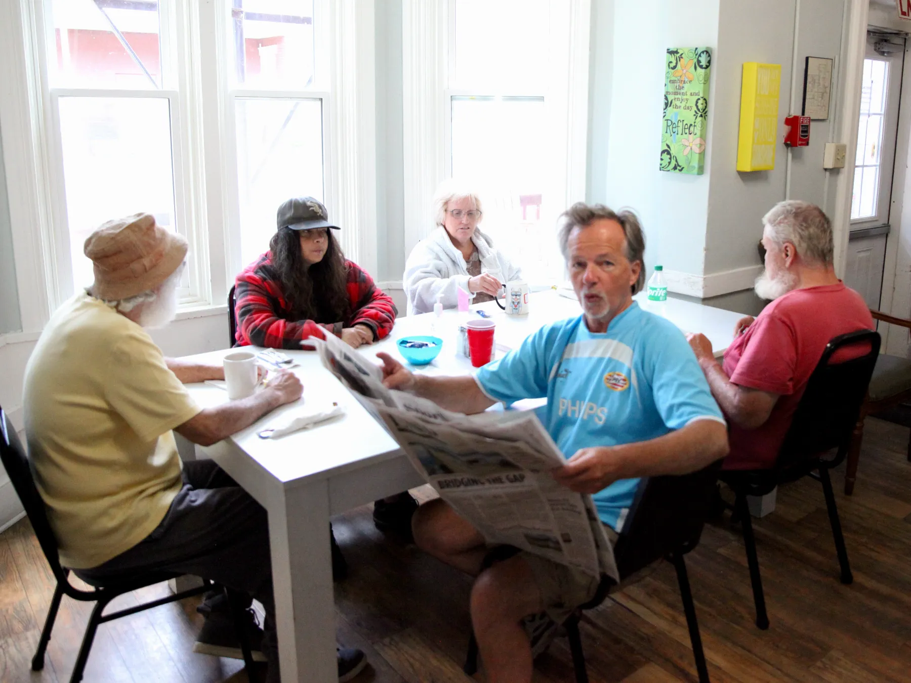 Residents enjoying a meal and conversation.