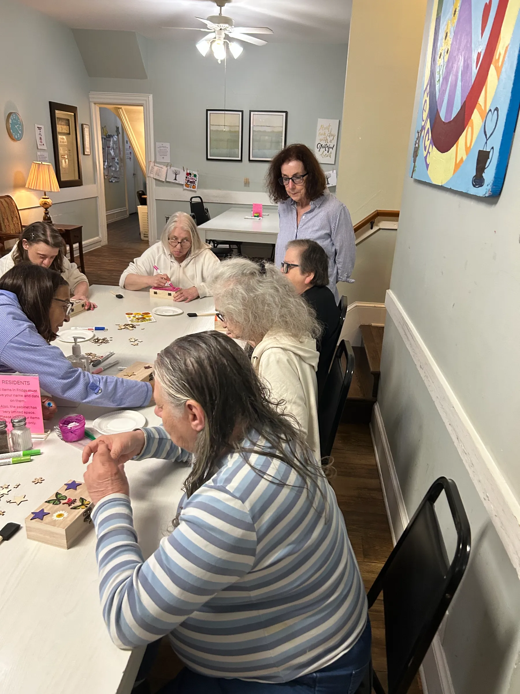 Residents engaged in a group activity at a table.