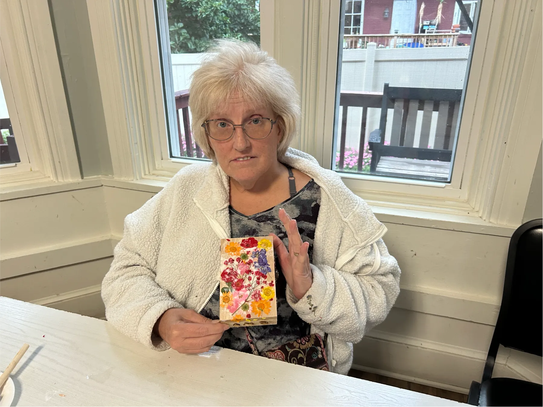 Resident creating art in an indoor common area.