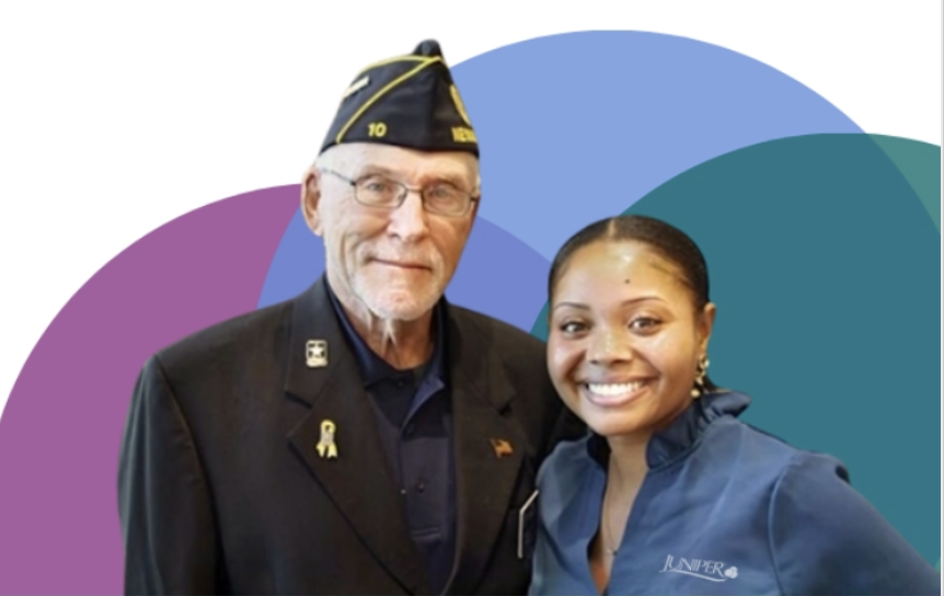 A veteran and a staff member smiling together