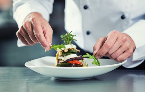 A chef plating a gourmet meal.