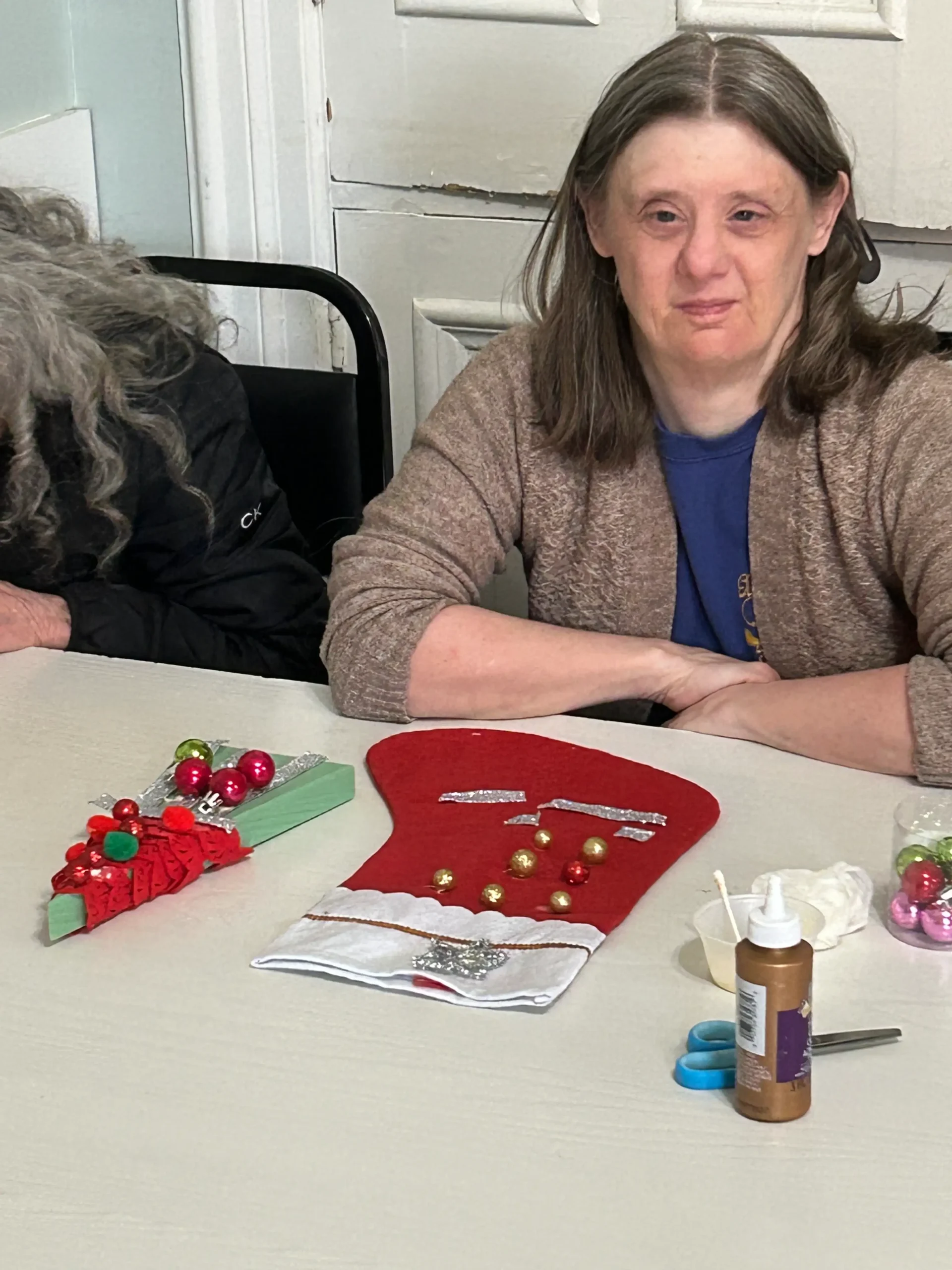 Resident engaged in holiday craft activity.
