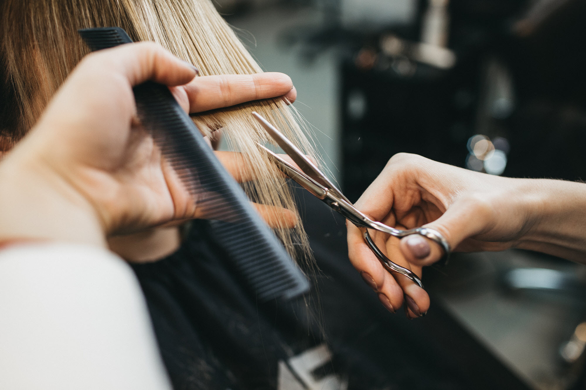 A hairstylist cutting a client's hair.