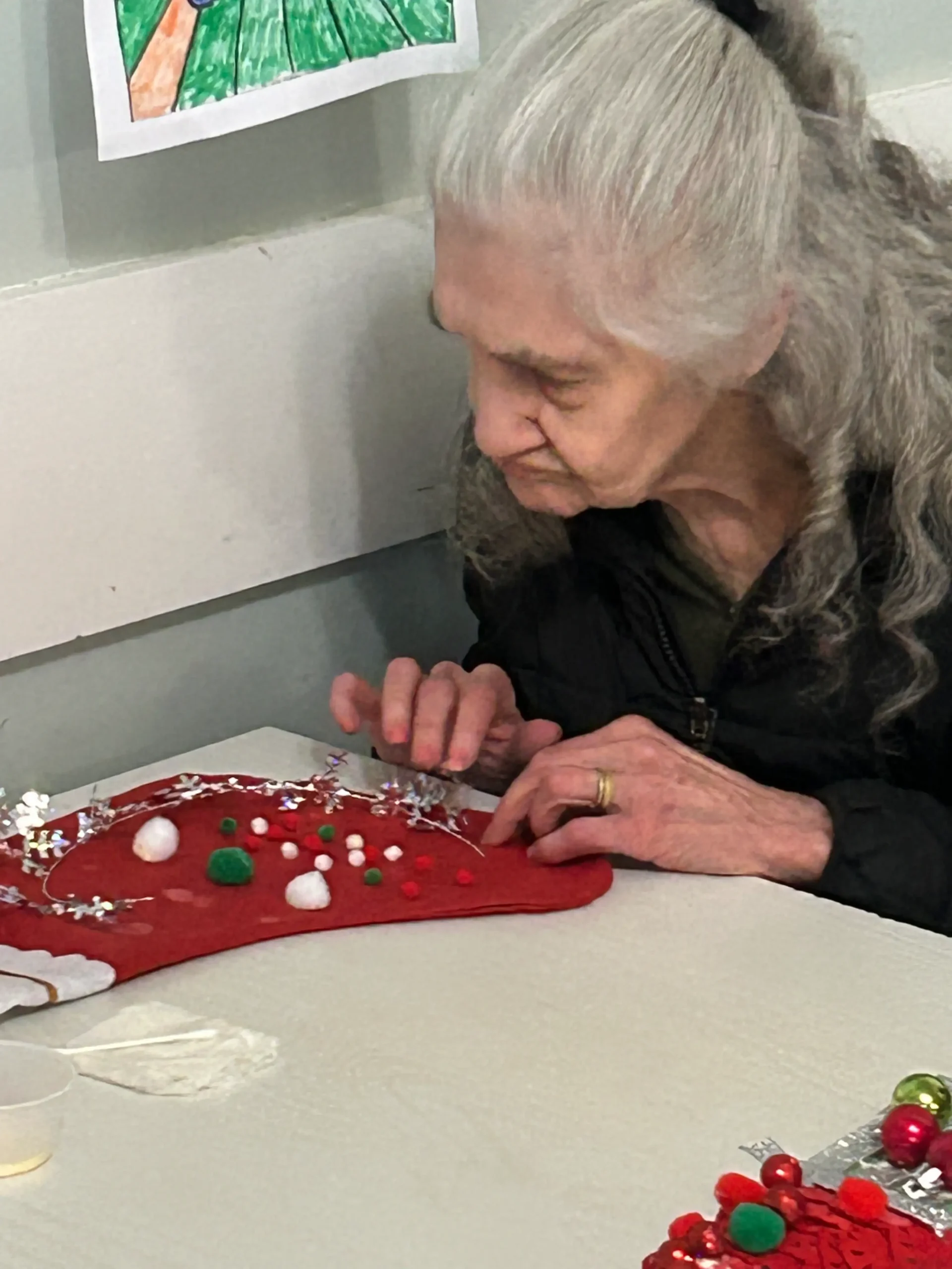Senior woman engaged in crafting activity.