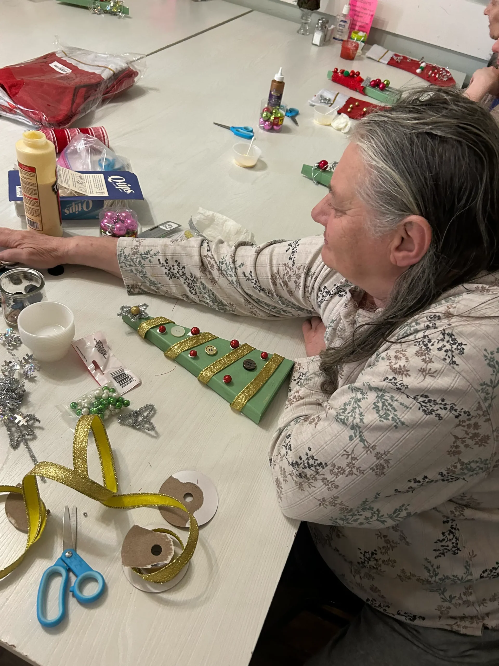 Resident participating in a holiday crafting activity.