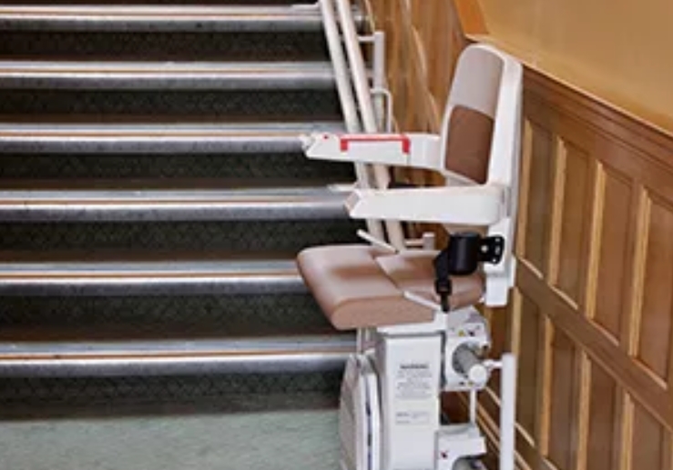 Stairlift positioned at the bottom of a staircase.