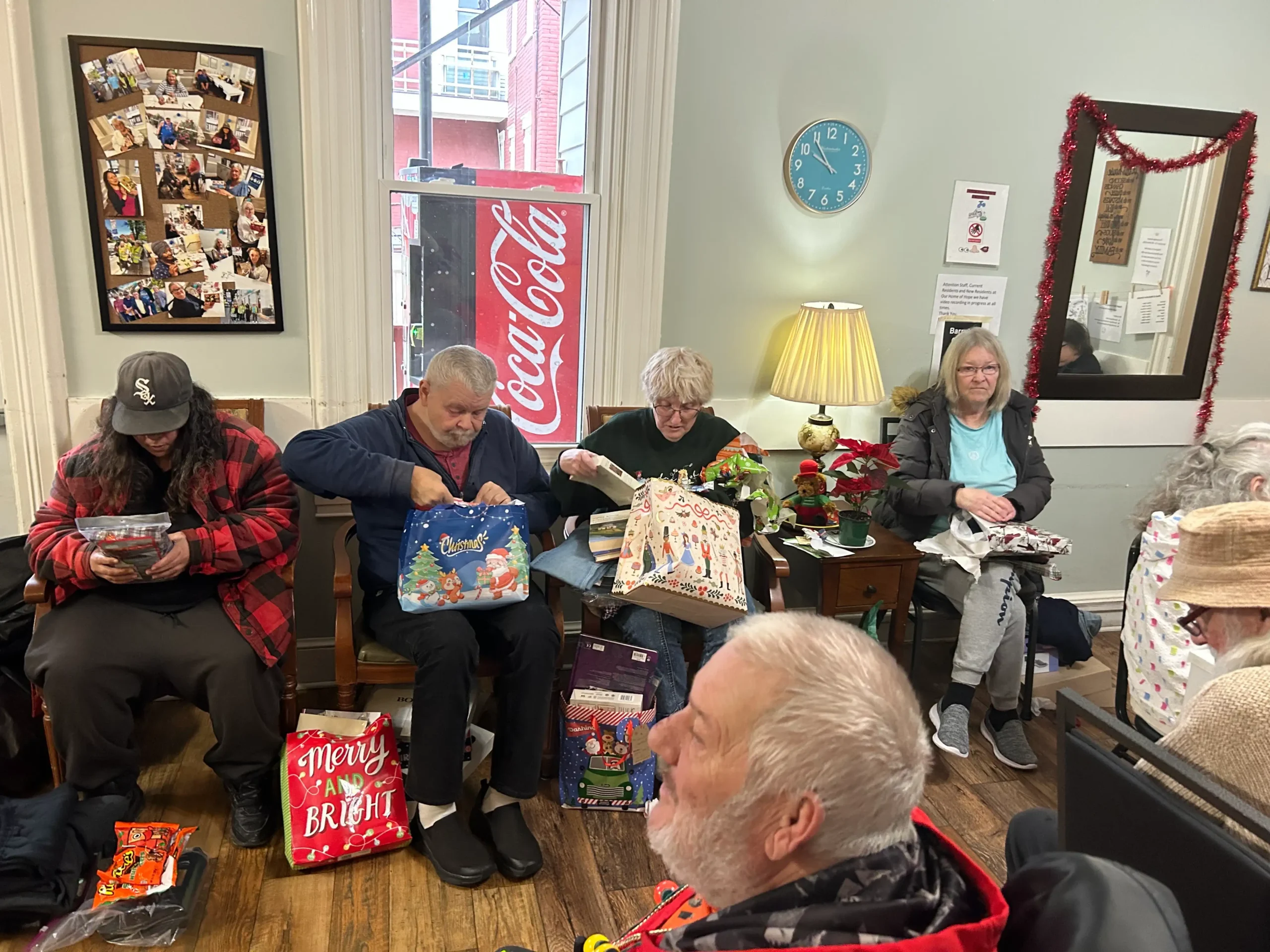 Residents enjoying gift unwrapping activity.