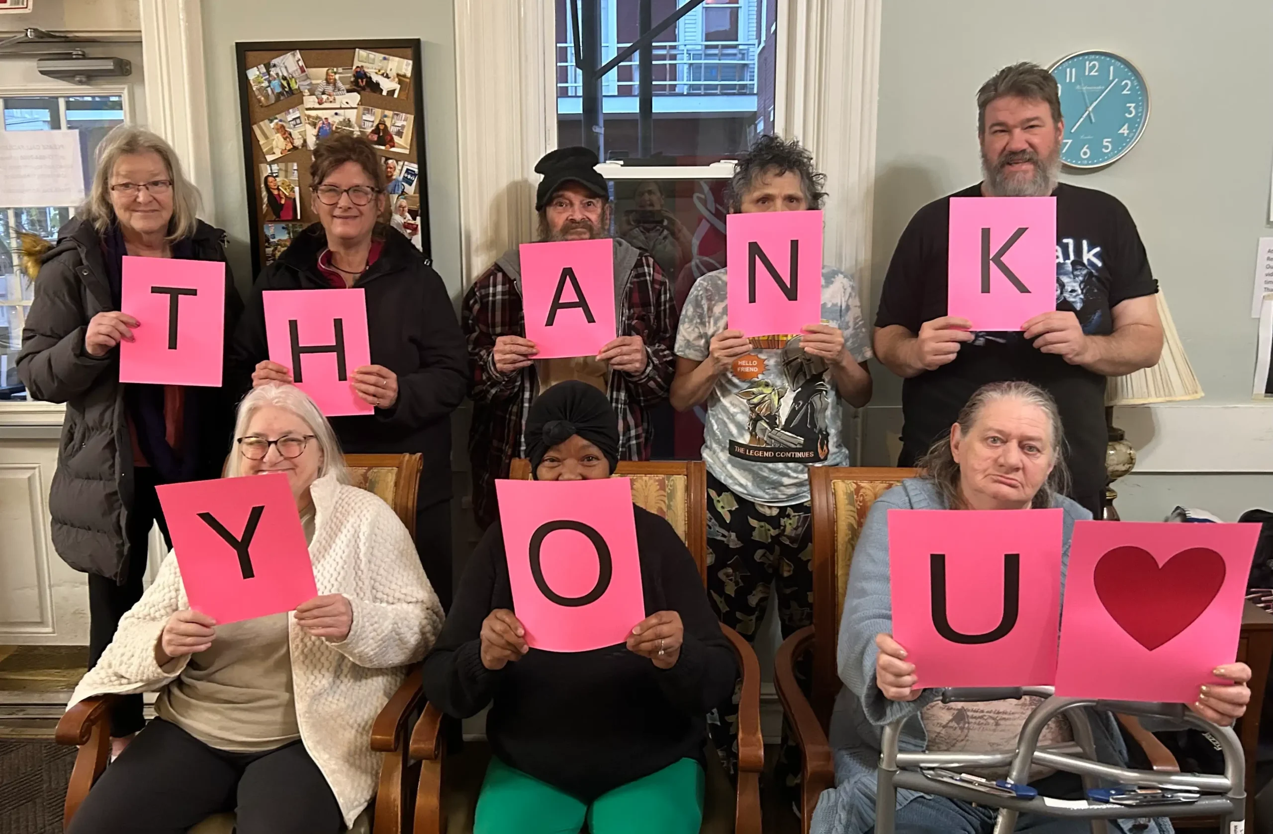Residents holding signs expressing gratitude.