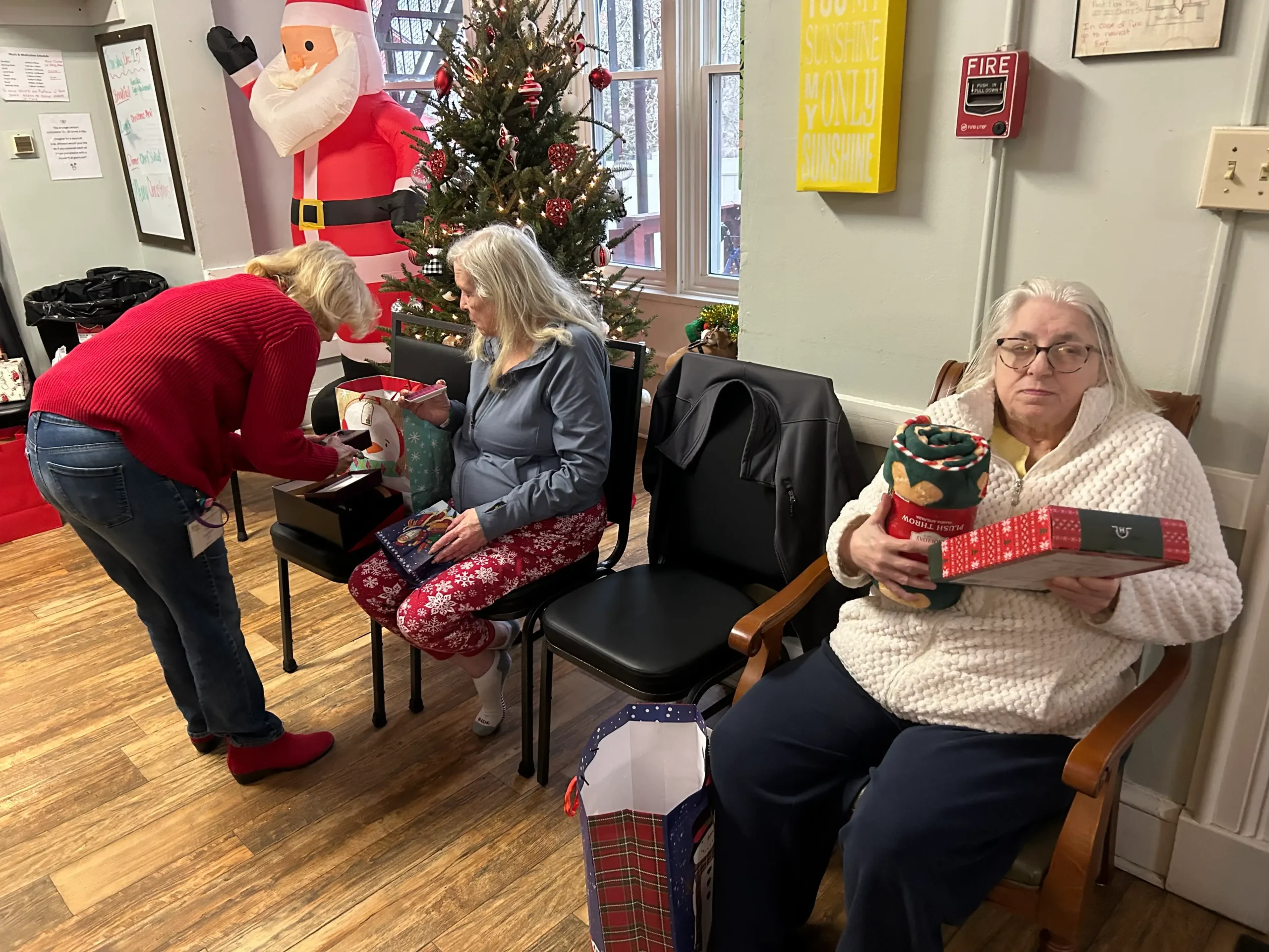 Residents enjoying a holiday gift exchange activity.