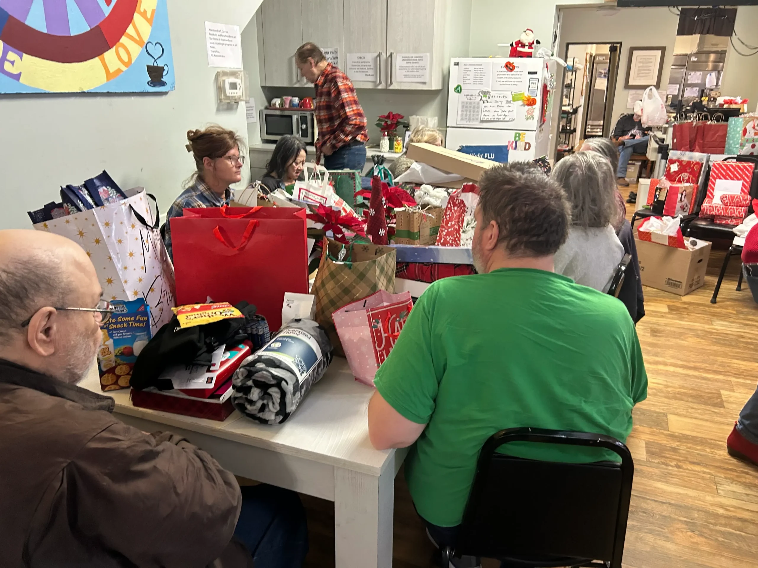 Residents enjoying a holiday party with gifts and decorations.