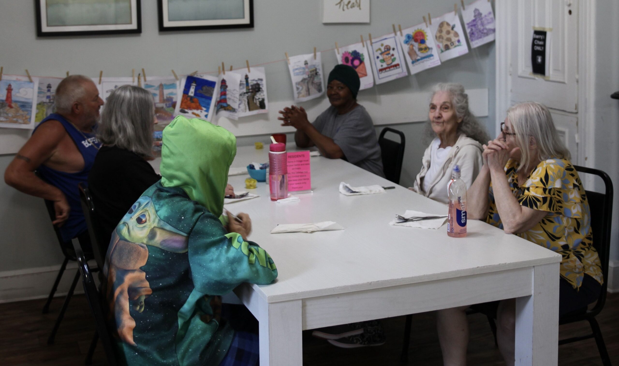 Residents enjoying time together at a dining table.