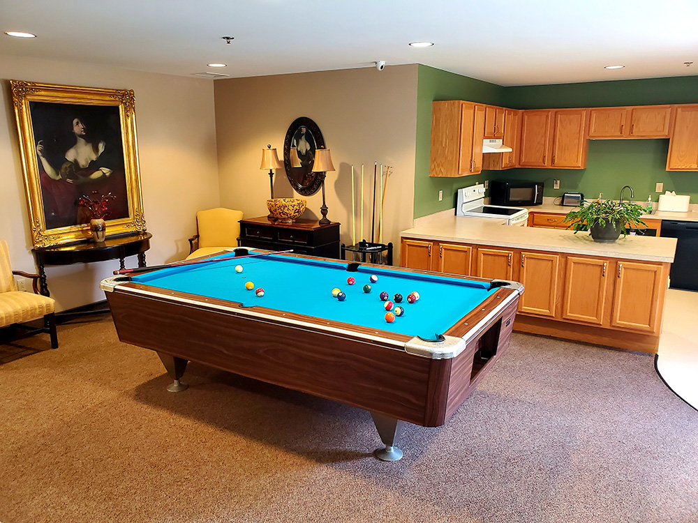 Common area with a pool table and kitchenette