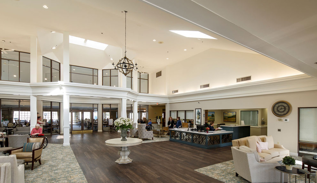 Bright interior common area with residents and staff.