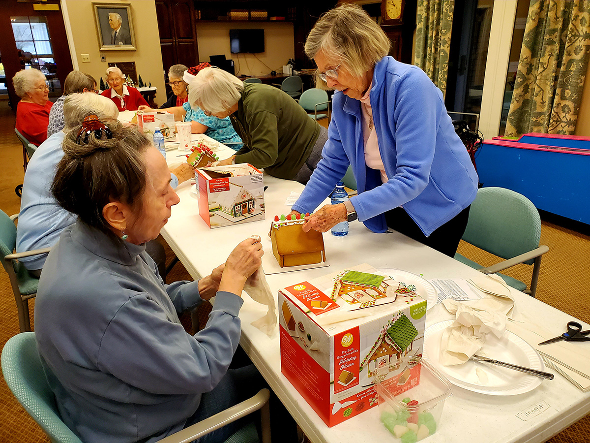 Residents engaging in a gingerbread house activity