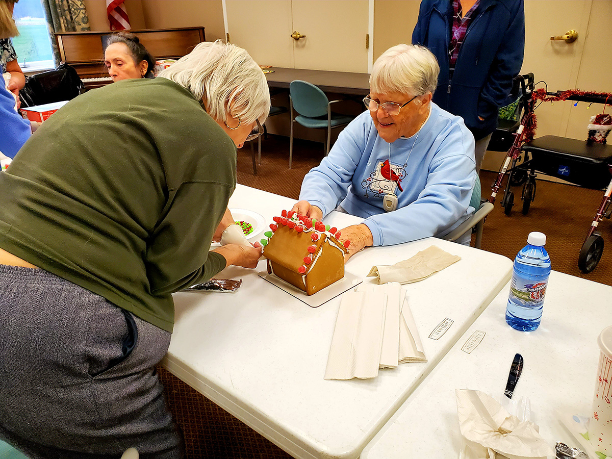 Residents engaging in a gingerbread house activity.