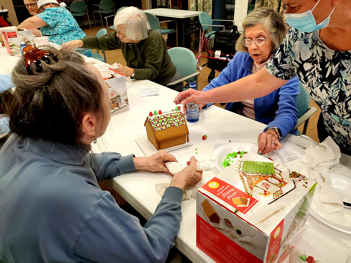 Residents engaging in a gingerbread house activity.