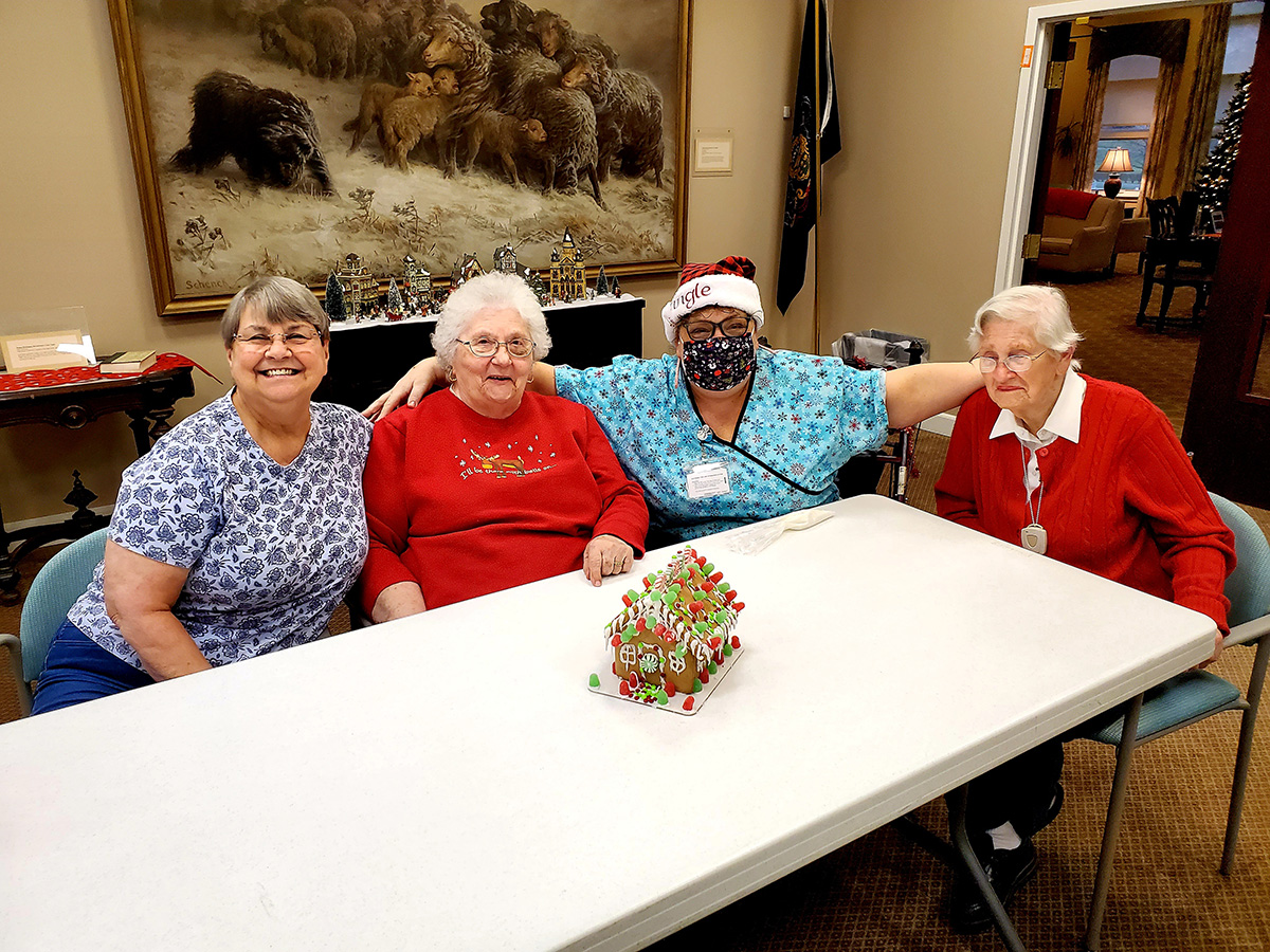 Residents and staff celebrate together indoors.