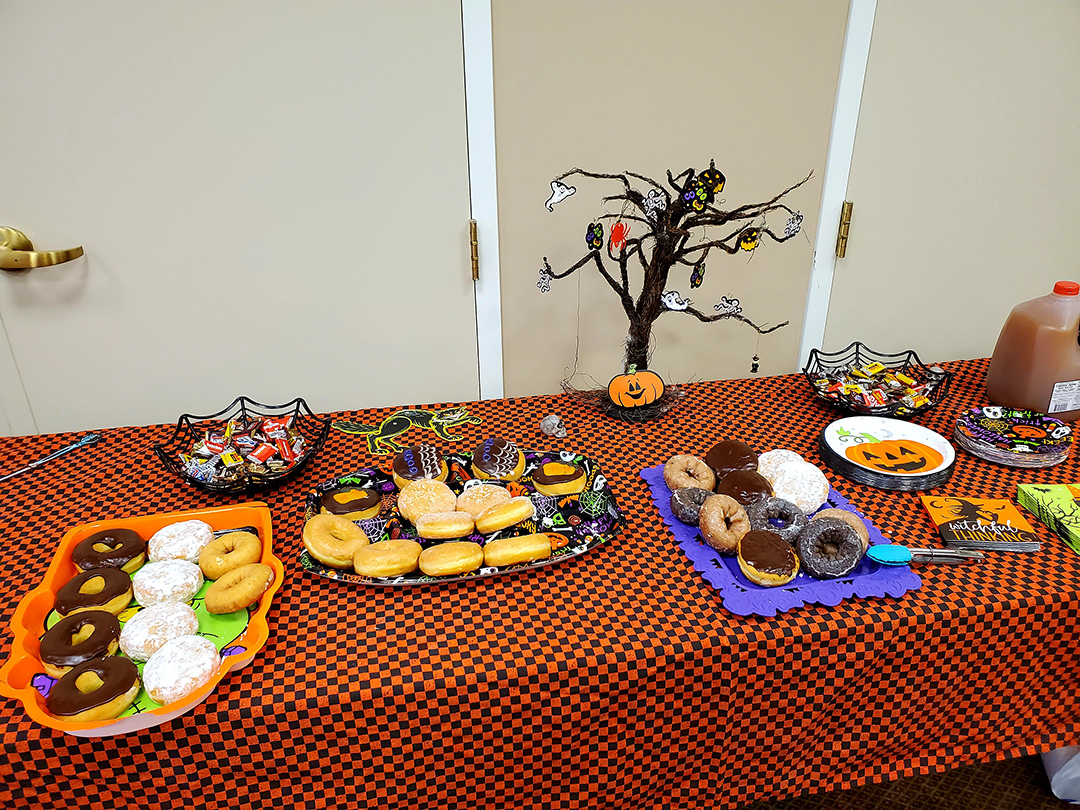 Decorative table with Halloween-themed snacks and drinks.