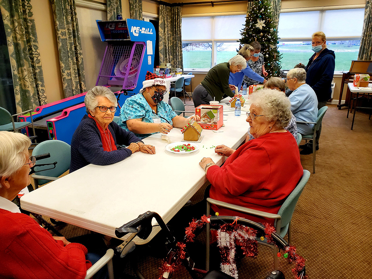 Residents enjoying a gingerbread house activity