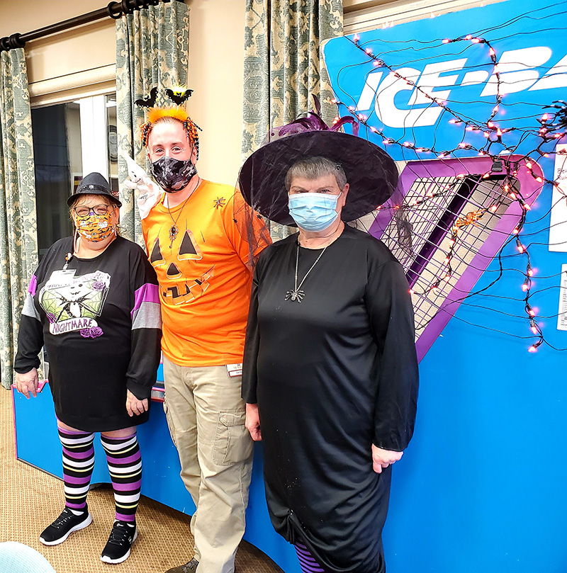 Residents and staff in costumes during a celebration