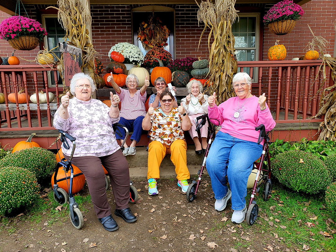 Residents enjoying a fall-themed outdoor gathering.