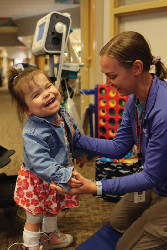 Child enjoying playful interaction with a staff member
