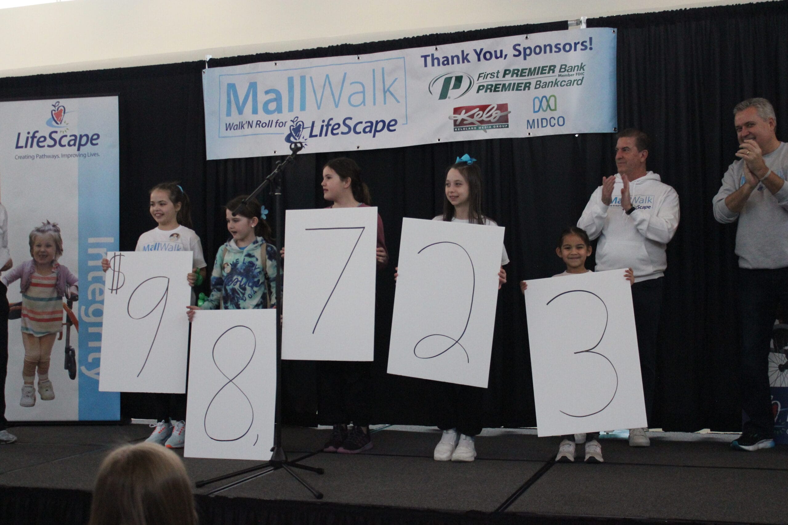 Children holding numbers at a charity event.