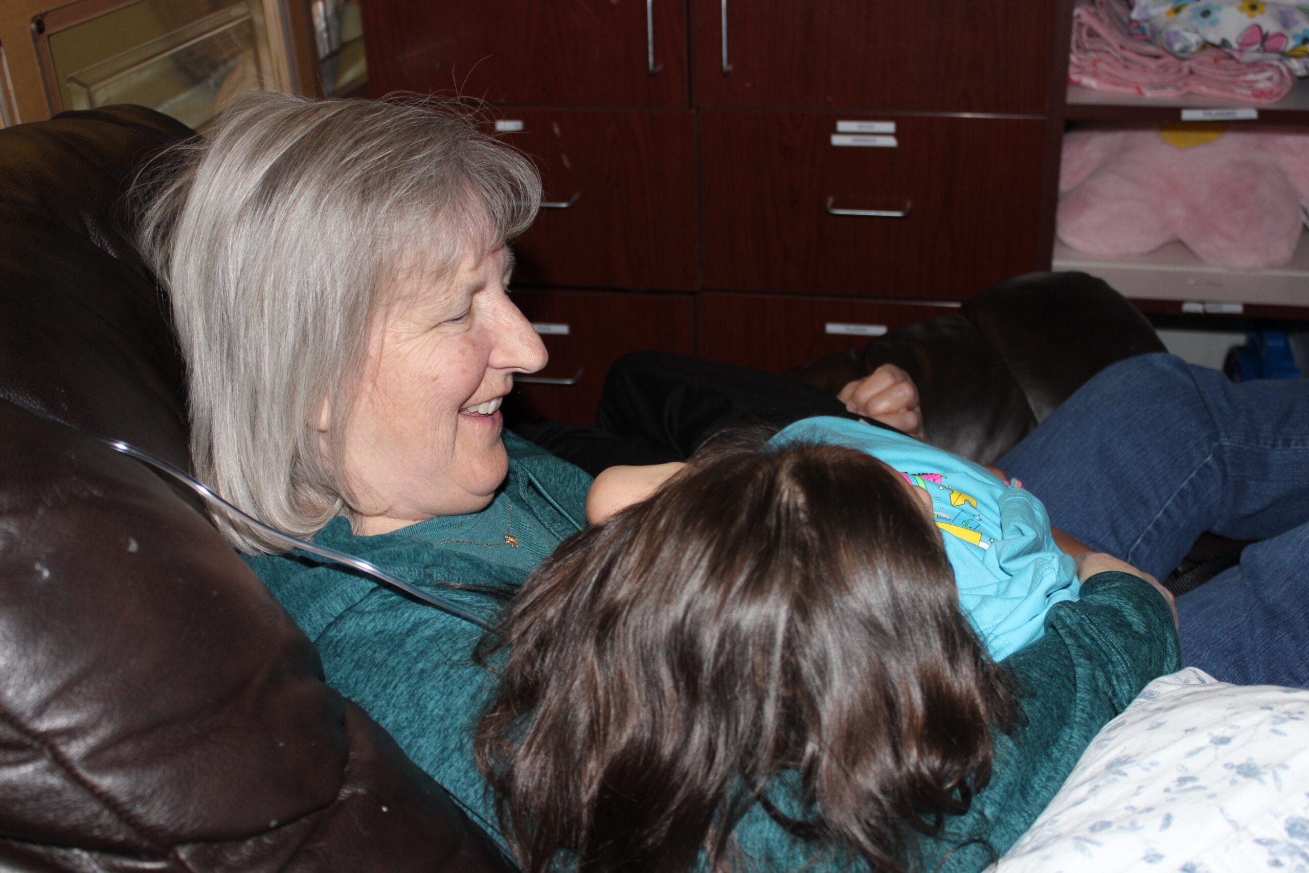 Smiling resident interacting with a child.