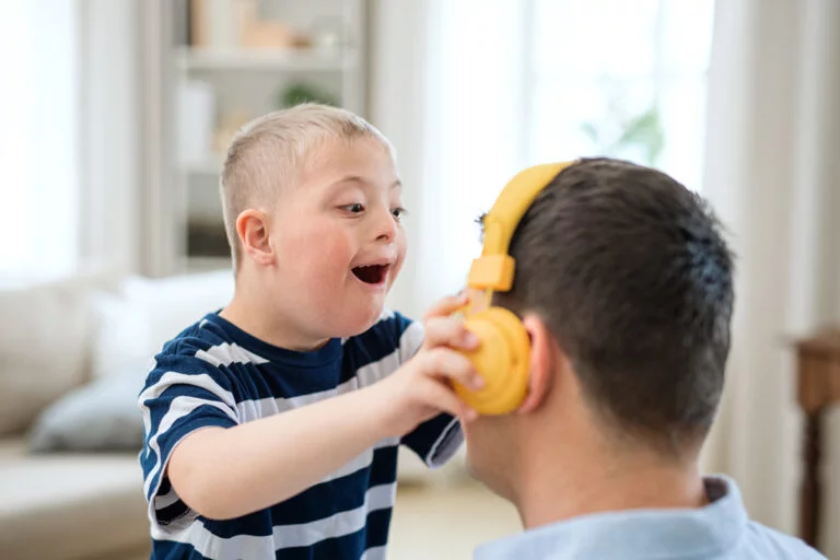 Child joyfully playing with headphones.