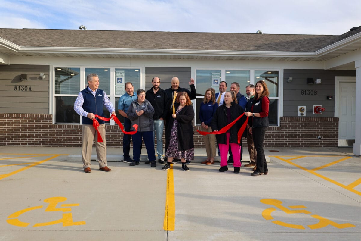 Ribbon-cutting ceremony with staff and residents.