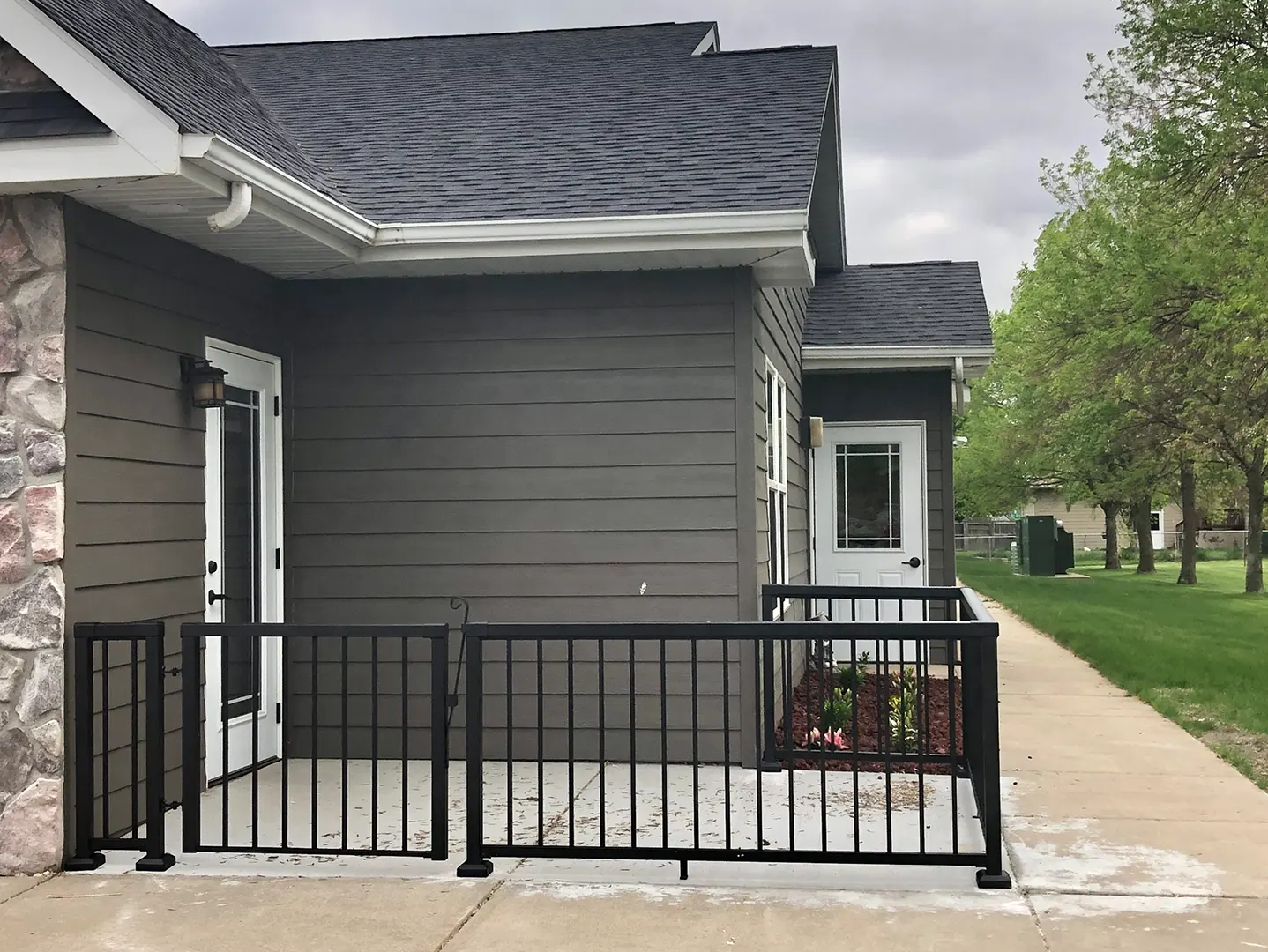 Exterior view of a facility entrance with railings.