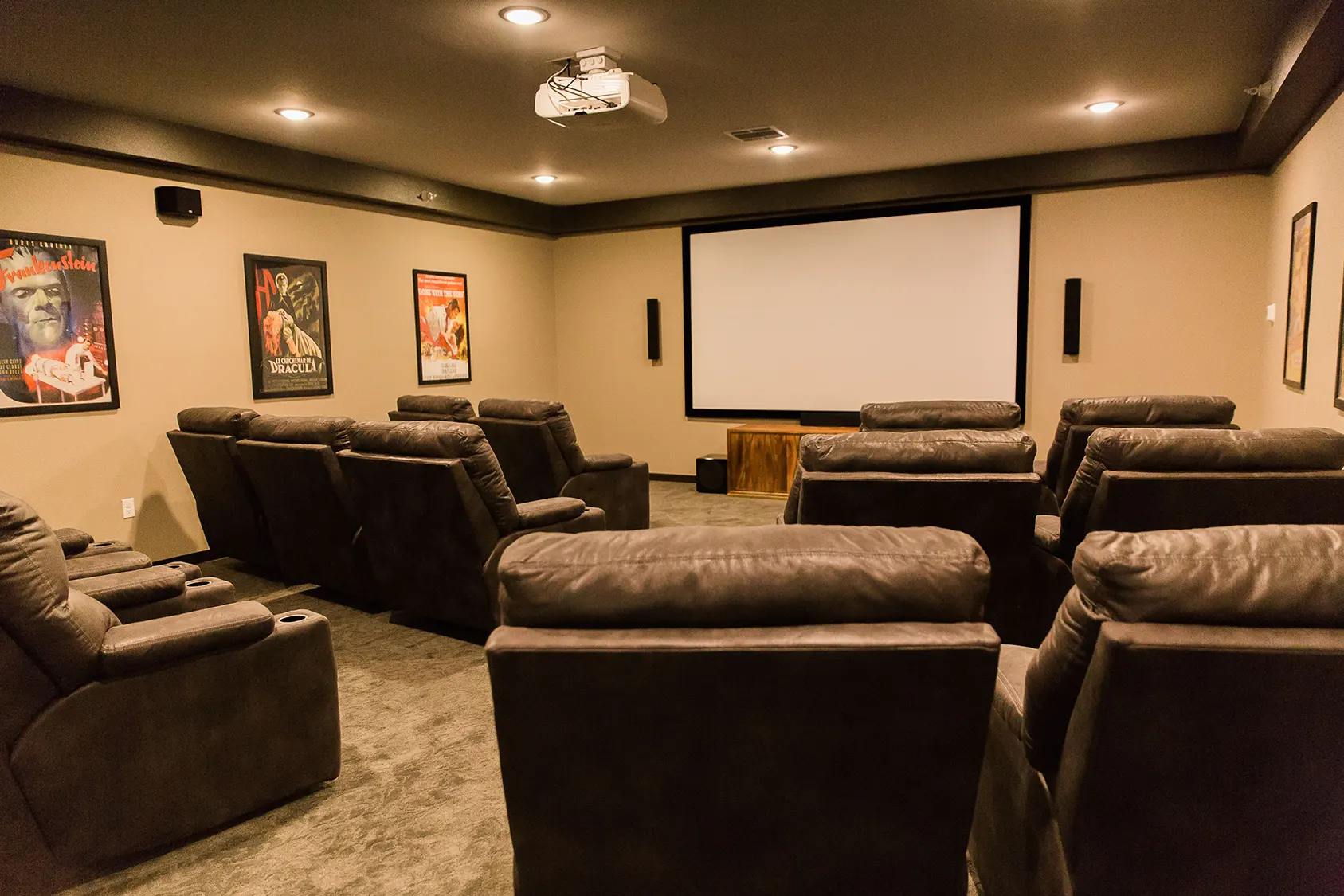 Cozy theater room with reclining seats and screen