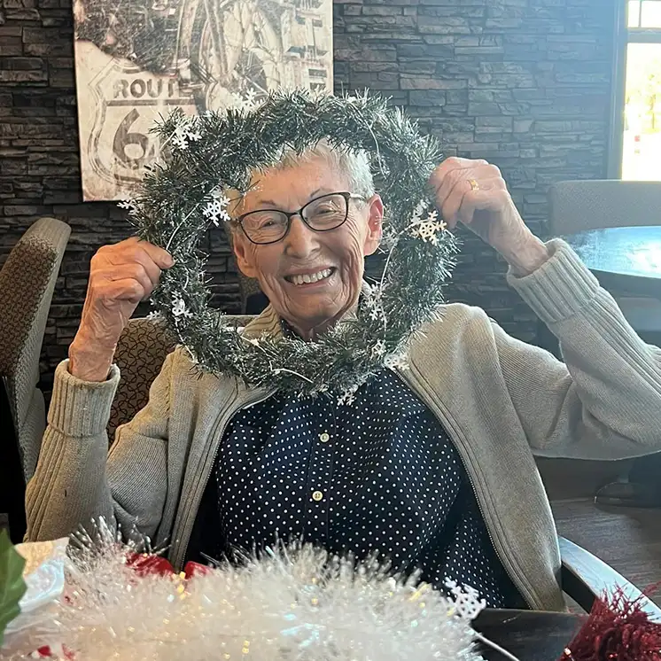 Resident celebrating with a festive wreath.