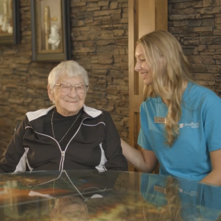 Staff member interacting with an elderly resident.