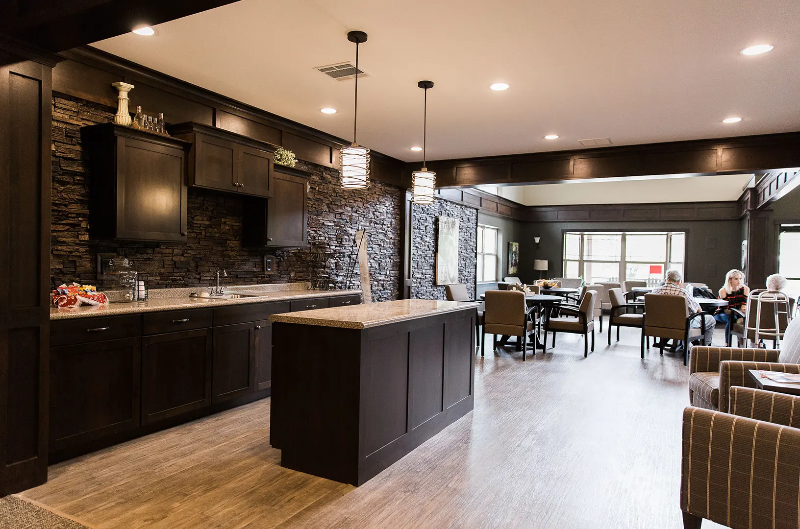 Common area with seating and kitchen appliances.