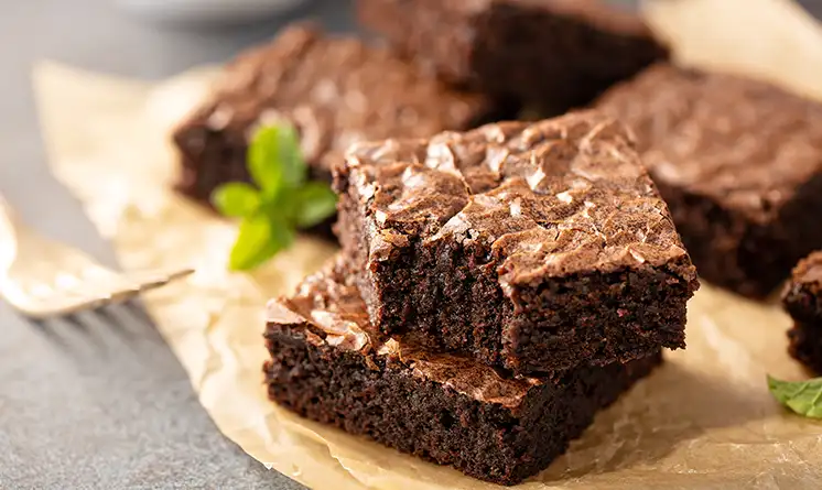 Delicious brownies on a rustic surface.