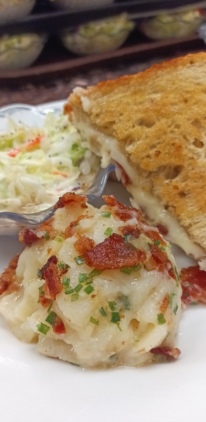 Close-up of a meal with coleslaw and a sandwich.