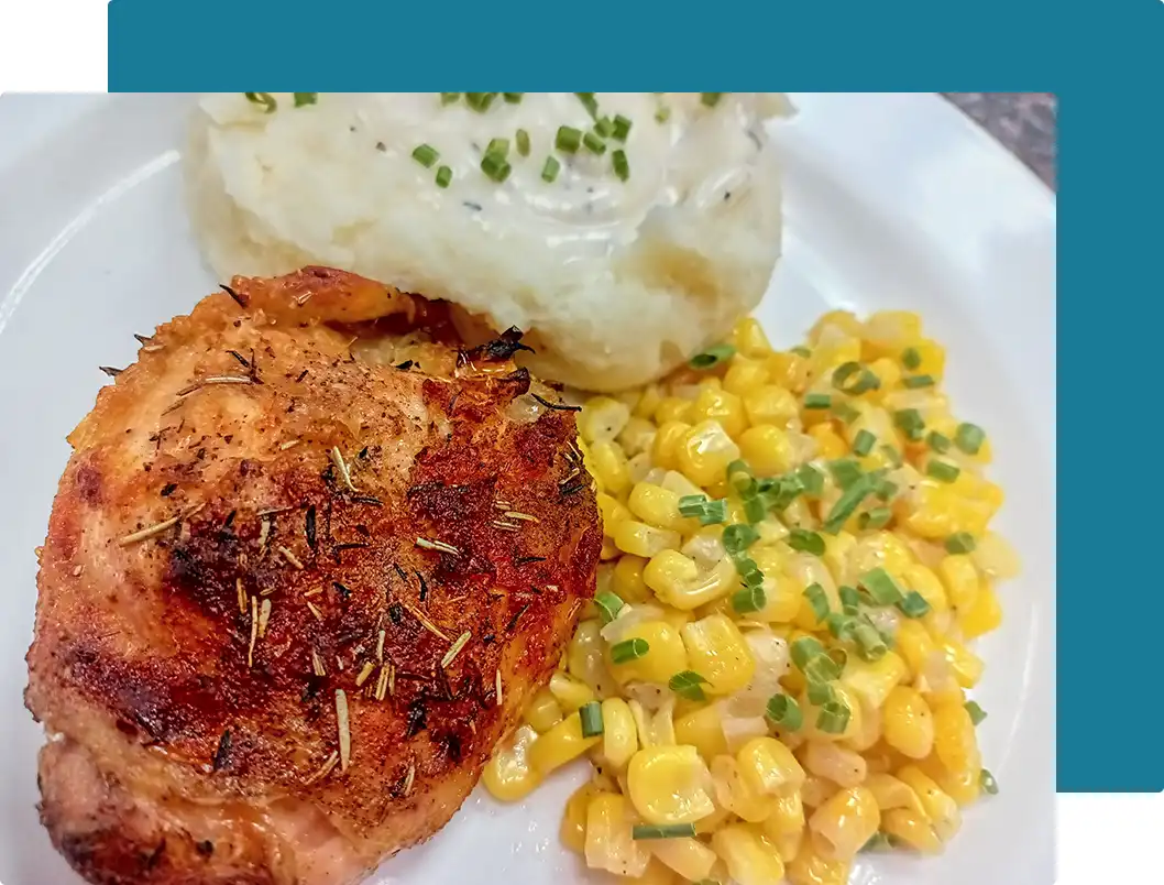 Plate of roasted chicken with sides