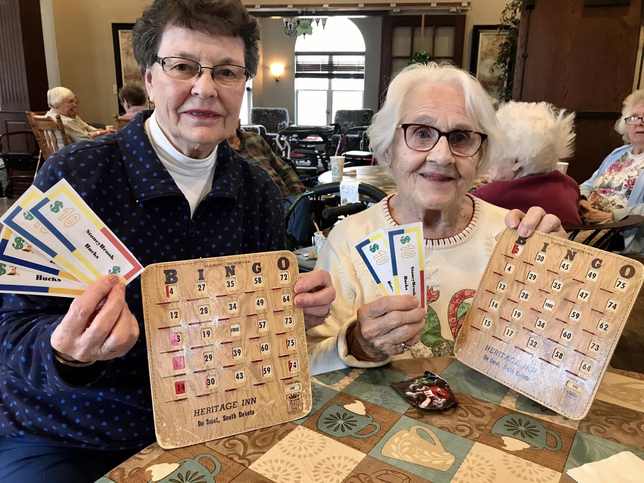 Two residents enjoying a Bingo game together.