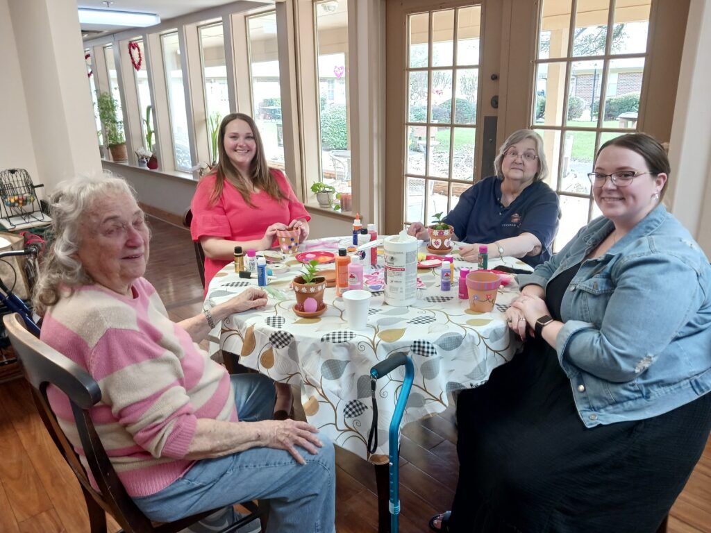 Residents and staff engaging in a craft activity.