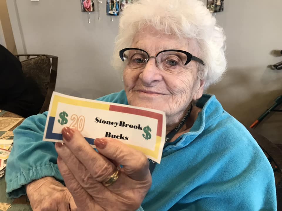 Senior resident holding StoneyBrook Bucks