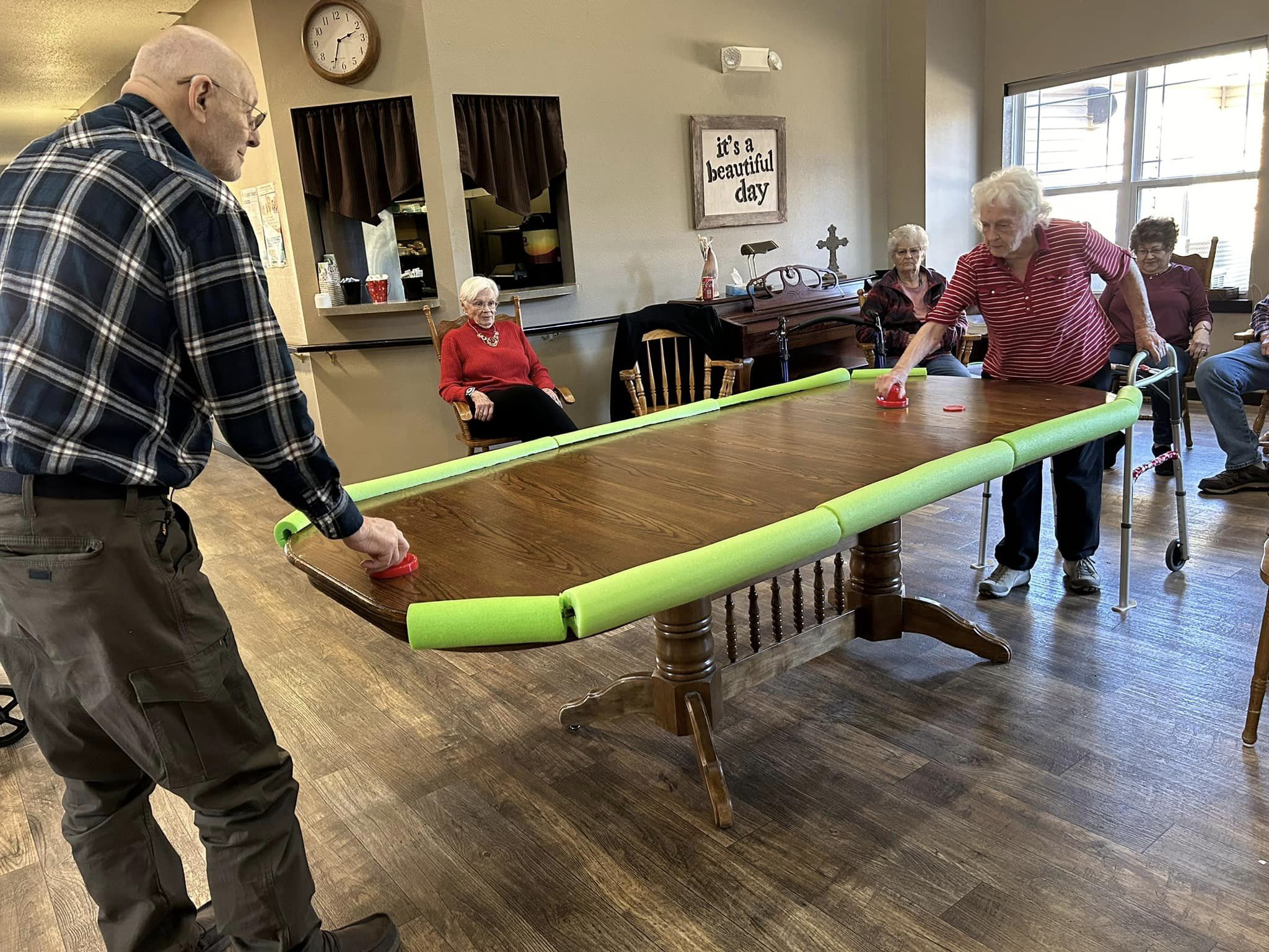 Residents engaging in a game at a large table