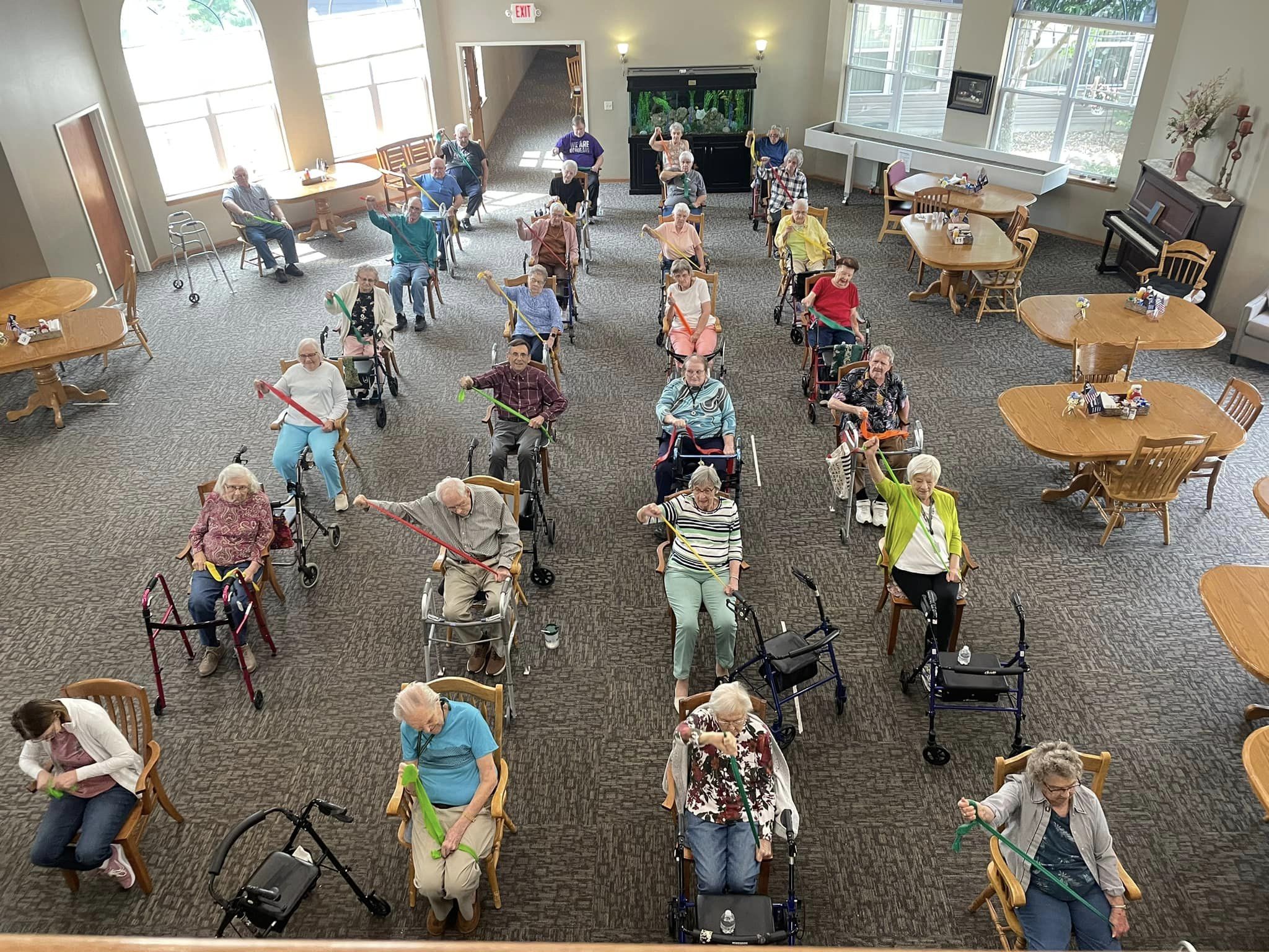Residents participating in a seated exercise class.