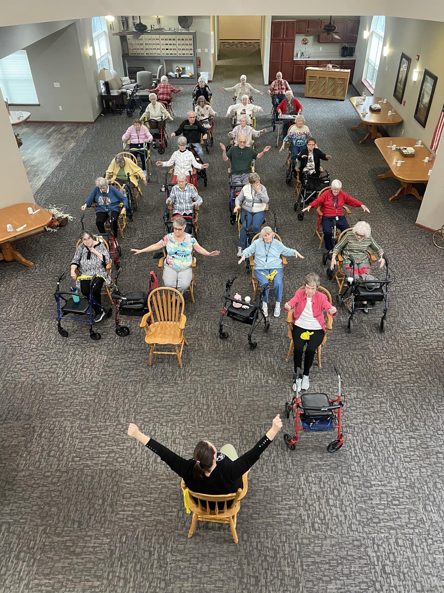 Residents participating in a seated exercise class.