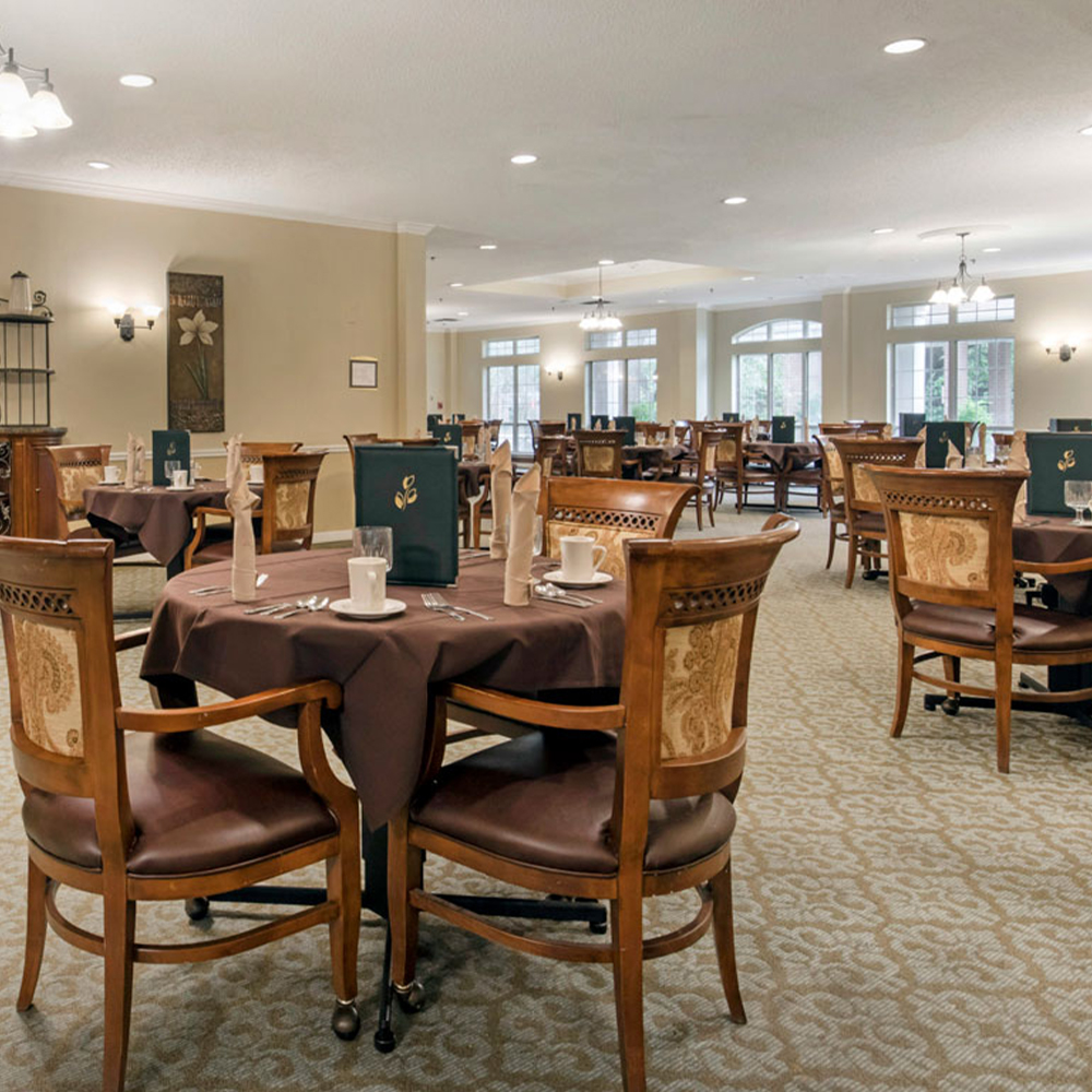 Dining area with tables and chairs set for service.